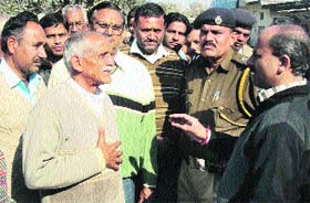 Government officials pacify agitating villagers to lift their dharna on the Indora-Pathankot link road on Monday