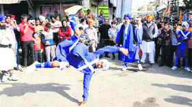 A youth peforms daredevil feats during at a show held as part of Nagar Kirtan held in Jalandhar on Monday two days ahead of Gurpurb.