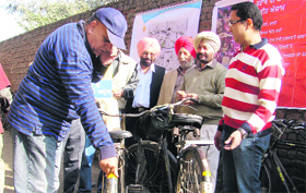 Members of the ArriveSAFE and representatives of Kalsi Group put reflectors on bicycles as a part of Firefly Project in Jalandhar on Monday.
