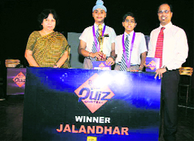Gurnoor and Namit, students of Apeejay School, receive a trophy at the Bournvita Quiz contest in Jalandhar.