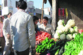 Municipal council employees argue with a vegetable vendor in Mandi Ahmedgarh on Monday.