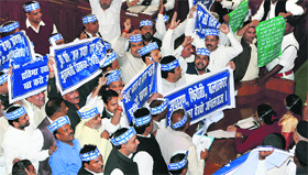 BSP members holding placards during a protest in the Assembly in Lucknow on Monday.