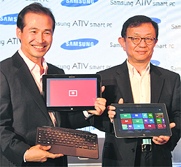 Samsung India VP (IT & mobile) Taeho Roh (L) and VP (IT solutions) Jin Park at a press conference to launch the companys Windows 8 based Smart devices in New Delhi on Tuesday.
