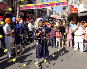 A youth displays his martial art skills during a procession held in the city on the eve of the birth anniversary of Guru Nanak Dev, the first Guru of the Sikhs, on Tuesday.