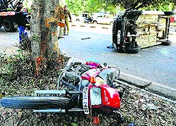 A motorcycle and a car lie oveturned after an accident at the road dividing Sectors 35 and 36 in Chandigarh on Tuesday
