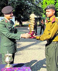 Col PK Kumaria, Commandant, RIMC, presents the trophy to the leader of the section in Dehradun on Tuesday