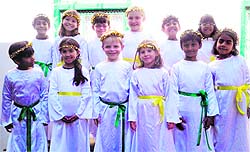 Students of Woodstock School dressed as angels ready to greet Santa Claus in Mussoorie on Tuesday