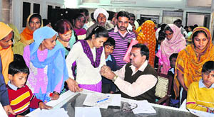 A doctor examines patients at a medical check-up camp organised in the Civil Hospital in Karnal on Tuesday. 