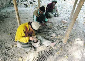 CRAFTY HANDS AT WORK: Men work on mortar bowls, locally known as Neaam, in Panthachowk on the outskirts of Srinagar