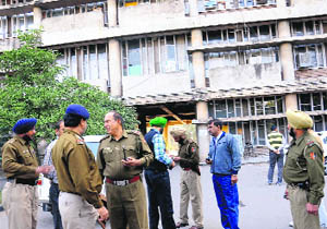 Police personnel outside the Chandigarh Police Headquarters where a resident tried to set himself on fire on Wednesday. 