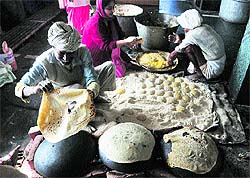 Devotees make langar on the birth anniversary of Guru Nanak Dev at a gurdwara in Shimla on Wednesday