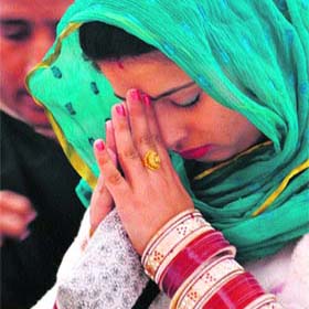 A devotee offers prayer on the occasion of the birth anniversary of Guru Nanak Dev in Jammu on Wednesday