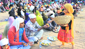 A little girl distributes langar at a gurdwara on the birth anniversary of Guru Nanak Dev in Jalandhar on Wednesday