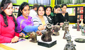 Students take a look at sculptures at the four-day annual art exhibition "Creative Contour-2012" in Lovely Professional University near Jalandhar