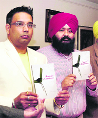 Charanjit Singh Minhas (right) releases his book Annas Canteen in Jalandhar.