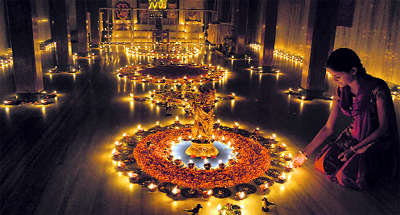 A girl lights lamps on Kartik Purnima on the Balaji temple premises in Karad, Maharashtra, on Wednesday