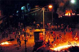 Demonstrators clash with police on Tuesday as they were attempting to burn the local headquarters of Egypts ruling Freedom and Justice Party and a police station in Mansura, some 120 km north of Cairo