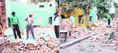 Construction workers demolish the old building in the Civil Lines police station, adjoining the court complex, where the new district administrative and police complex will come up, in Amritsar on Thursday. 