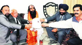 Surinder Billa (centre), who pledged his body for donation to Guru Nanak Dev Hospital for medical research and education, submits documents to the Medical Superintendent in Amritsar on Thursday. 