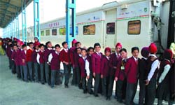 School students wait for their turn to experience and understand the enigmatic world of science, at Bathinda railway station where the Science Express - Biodiversity Special has been stationed
