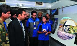 an employee explains a point to Deputy Commissioner Kamal Kishore Yadav on board the Science Express on Thursday. 