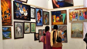 Visitors at the Art Festival view the works at Teachers Home on Thursday