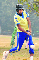 A player hits the ball during the Inter-College Softball Championship at the Panjab University in Chandigarh on Thursday.