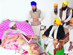 Sikh high priest Jathedar Balwant Singh Nandgarh of Takht Damdama Sahib inquires about the health of injured SGPC member Gurmeet Singh Tilokewala near Kalanwali in Sirsa on Thursday.