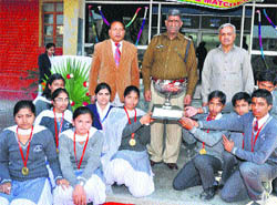  Naveen Kumar (centre), DSP, Pehowa, manager of the school Dr Kamdev Jha (right), and principal of the school NC Bindal (left) with the winners of Hansraj House on Monday. 