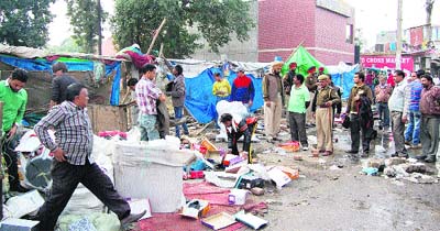 An MC team demolishes temporary encroachments in Jyoti Chowk in Jalandhar on Thursday.