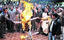 Workers of the Food Corporation of India hold a protest against the management in Jammu on Thursday