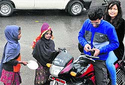 Beggars ask for alms at the bus stand in Jammu on Thursday