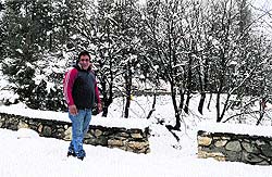 A tourist walks on snow at the ski resort of Gulmarg