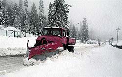 A snow-cutter clears a road after the seasons first snowfall