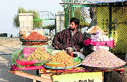 A roadside vendor waits for customers in Srinagar on Wednesday