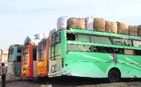 A sleeper coach loaded with cargo parked outside the Ludhiana bus stand