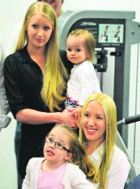 Ricky Pontings wife Rianna holds their daughter Emmy while Riannas sister Natalie (at back) holds the Pontings second daughter Matisse at the press conference on Thursday