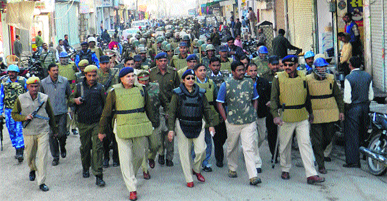 Deputy Commissioner J Ganesan, SSP Rajshree Singh and others during a flag march in a Sirsa market on Friday.