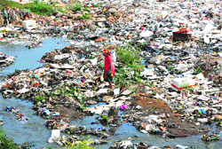 Heaps of garbage inside river Tawi near Jogi Gate cremation ground in Jammu on Friday. Tribune photo: Inderjeet Singh