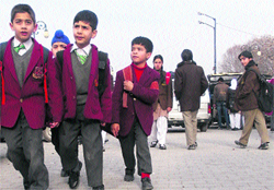 Children walk to their school in Srinagar on Friday. Tribune photo: Amin War
