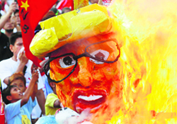 Protesters burn an effigy of the Philippines President Benigno Aquino against the labour policy in Manila on Friday.  Reuters