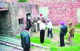 Police officials at the spot where boys body was found