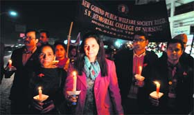 Nursing college students and Chief Parliamentary Secretary Navjot Kaur Sidhu take out a candlelight march to mark World AIDS Day in Amritsar on Saturday