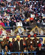 A huge crowd watches.