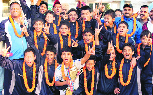 Members of the winning team in the U-16 footall tourney held in Mumbai during the 58th National School Games pose with their trophy in Chandigarh on Saturday.