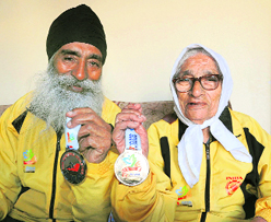 Gurdev Singh and Mann Kaur show their medals in Chandigarh on Saturday.