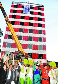 Staff, along with bhangra artistes, dance after the completion of a 10-storeyed building in 48 hours in Mohali