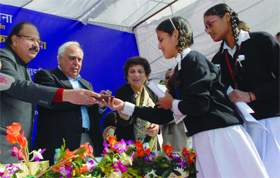 Union Minister of Telecom and IT Kapil Sibal with Delhi Health Minister Dr AK Walia and Education Minister Kiran Walia distributes mobile phones to a schoolgirl during the inauguration of the district-level child health referral fair at Sarvodaya Bal Vidyalaya at Rouse Avenue in New Delhi on Saturday.