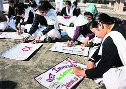 Students participate in poster making and slogan writing competitions to mark World AIDS Day organised by NSS unit at Government College for Women, Gandhi Nagar, in Jammu on Saturday