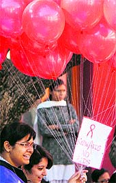Students of Government College for Women prepare to release red balloons inscribed with messages of Know AIDS No AIDS to mark World AIDS Day in Jammu on Saturday